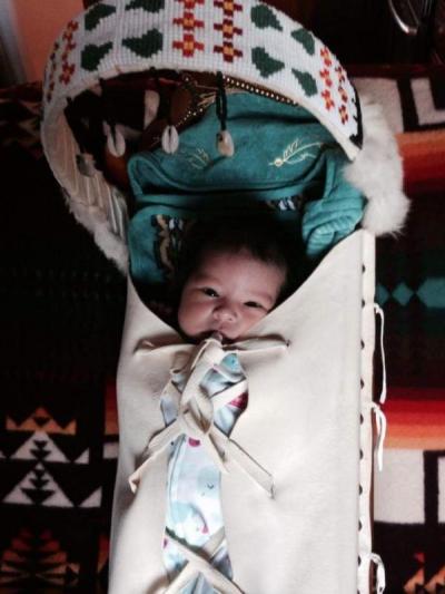 native american baby in a bassinet