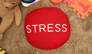 Image of a the word STRESS on a red circular pillow