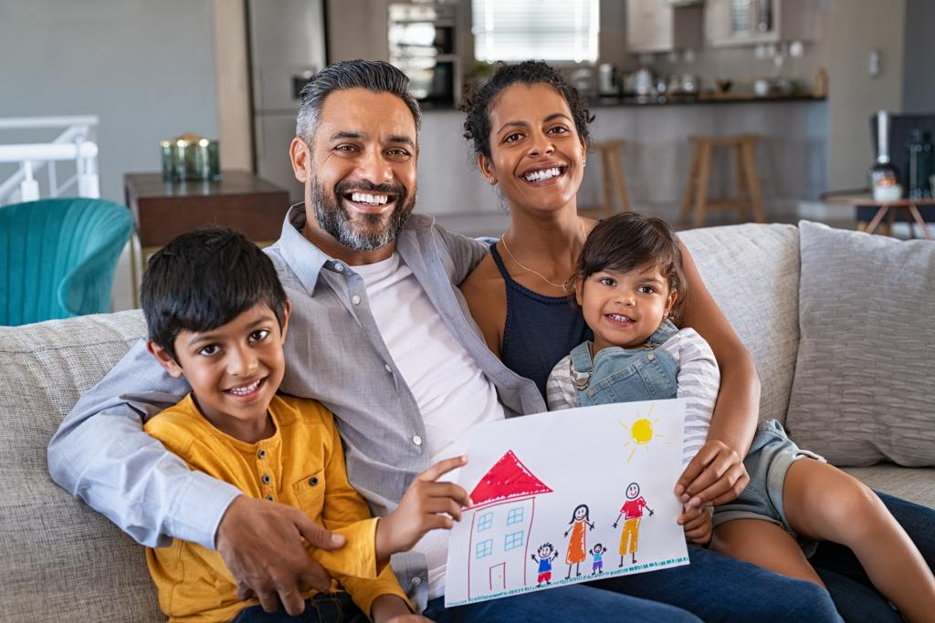 Family showing off their child's drawing