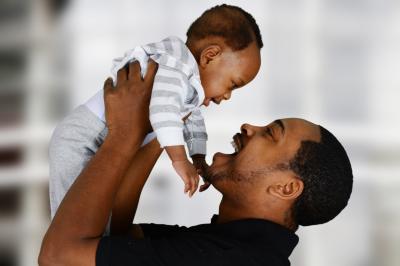 African American father holding baby