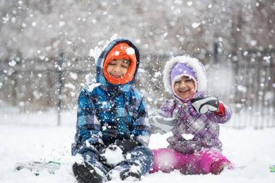 two kids playing in the snow