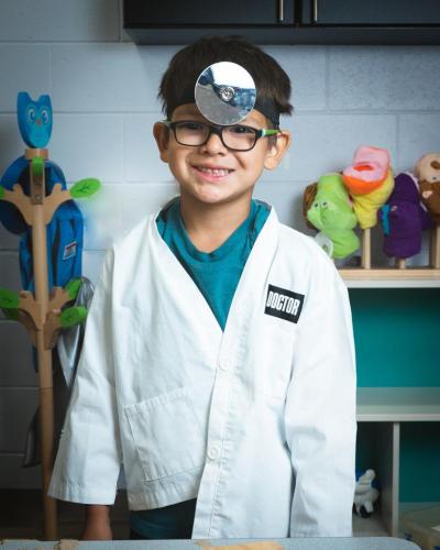 A young person dressed in a doctor outfit