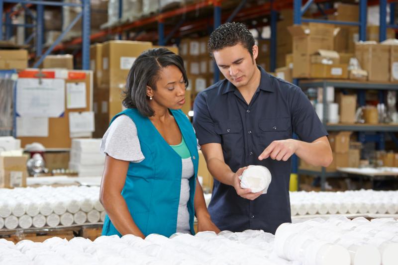A man and woman working in a warehouse