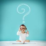 Baby in glasses with a question mark above head
