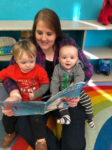 Picture of Jennifer Ahlert reading to two small children